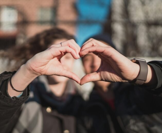 two person combine hand forming a heart hand gesture